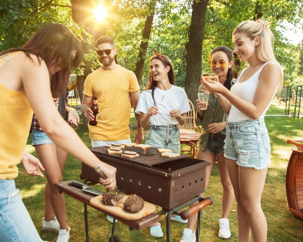happy-friends-are-having-beer-barbecue-party-sunny-day